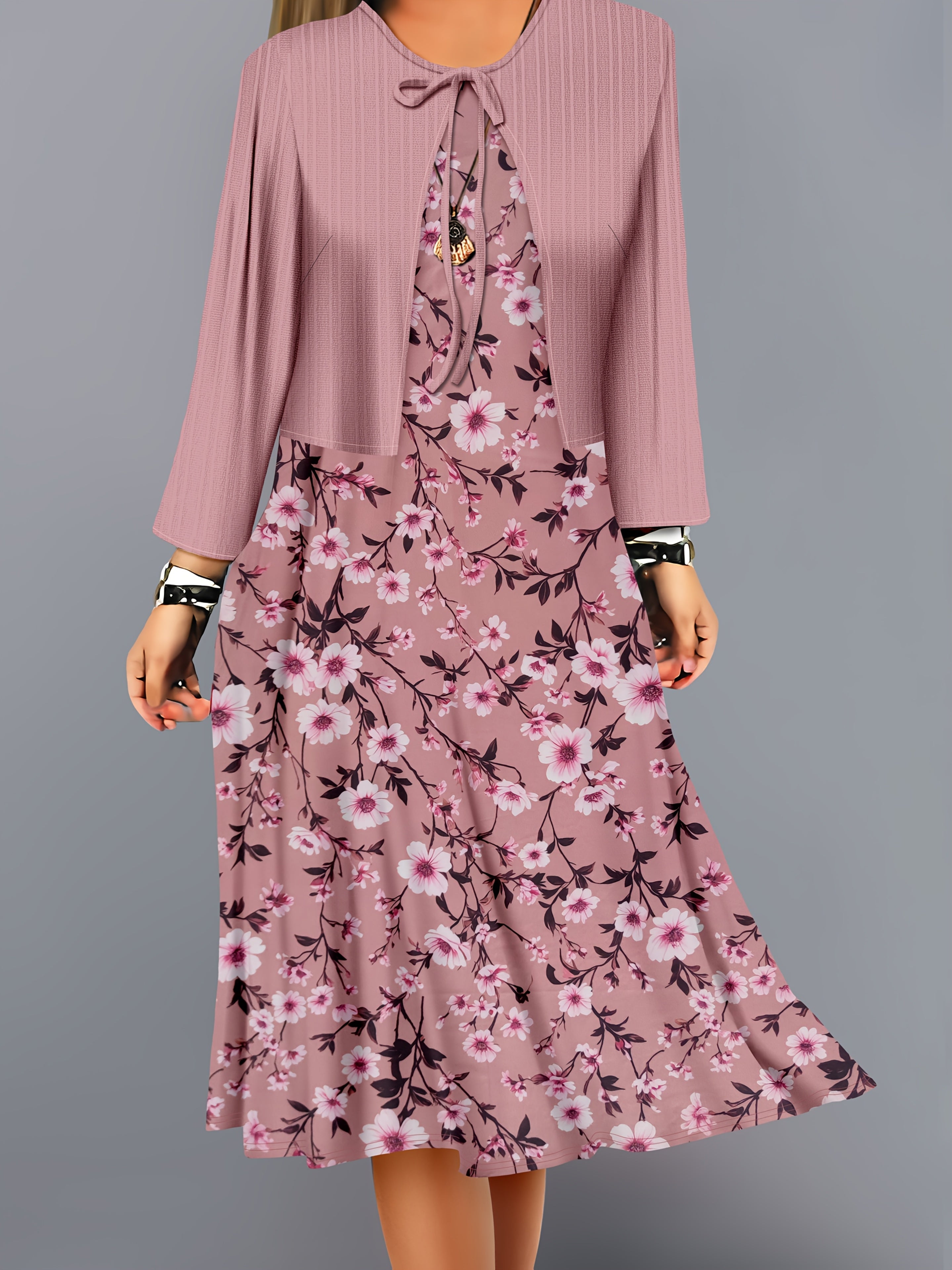 A two-piece set of solid-color striped small cardigan and floral printed dress for fashionable women